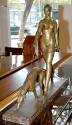 bronze statue of a woman walking her dog