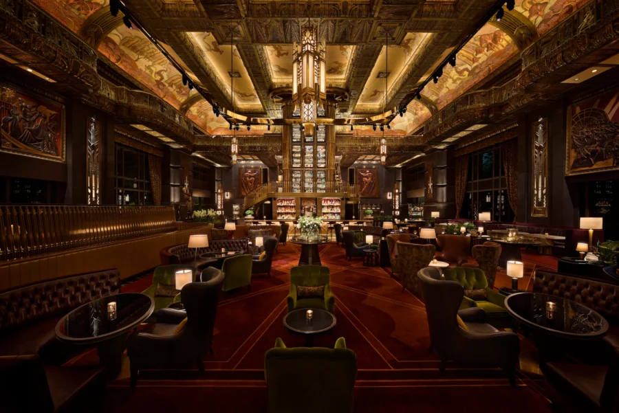 Elegant bar and lounge with vintage Art Deco design, warm lighting, and luxurious seating.