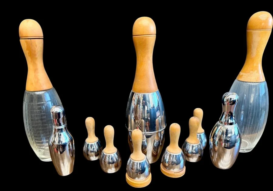 Set of wooden and metal bowling pin shaped bar tools on a black background