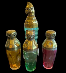 Set of colorful glass cocktail shakers with brass animal heads