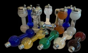 assorted colorful glass and metal dumbbells on a black background
