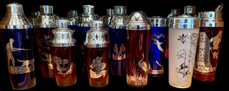 Row of vintage cocktail shakers with silver tops and etched designs