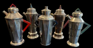 Five vintage metal coffee pots with geometric handles on a black background