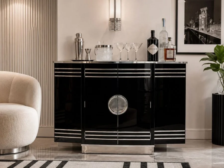 Modern home bar cabinet with black lacquer finish and cocktail setup in a stylish living room
