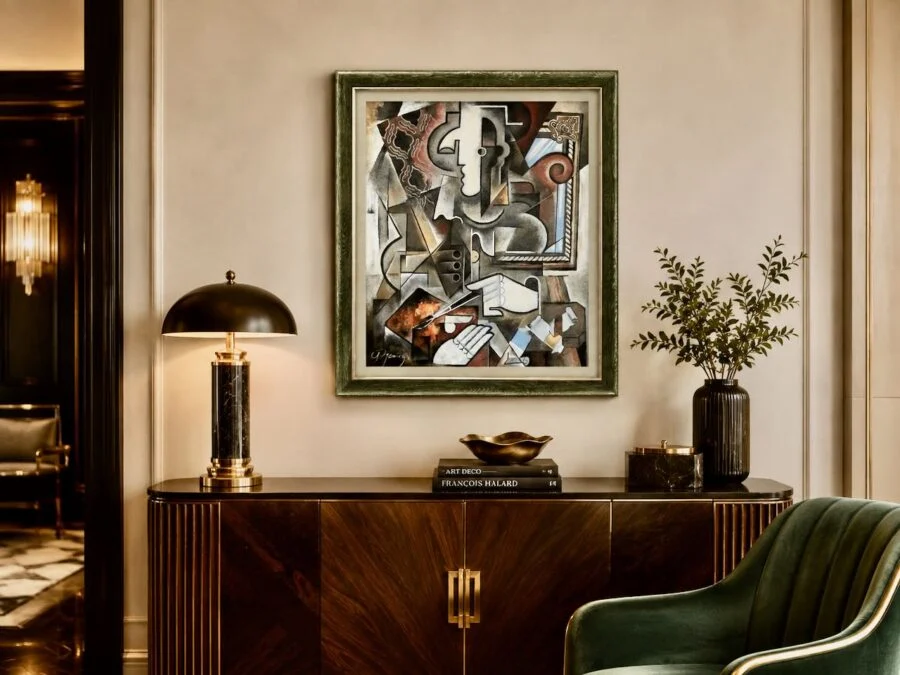 Elegant living room console with abstract framed artwork, brass lamp, and greenery