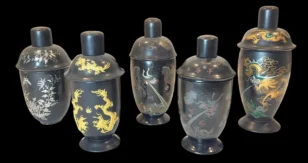 Set of five black lidded vases with intricate dragon and floral designs