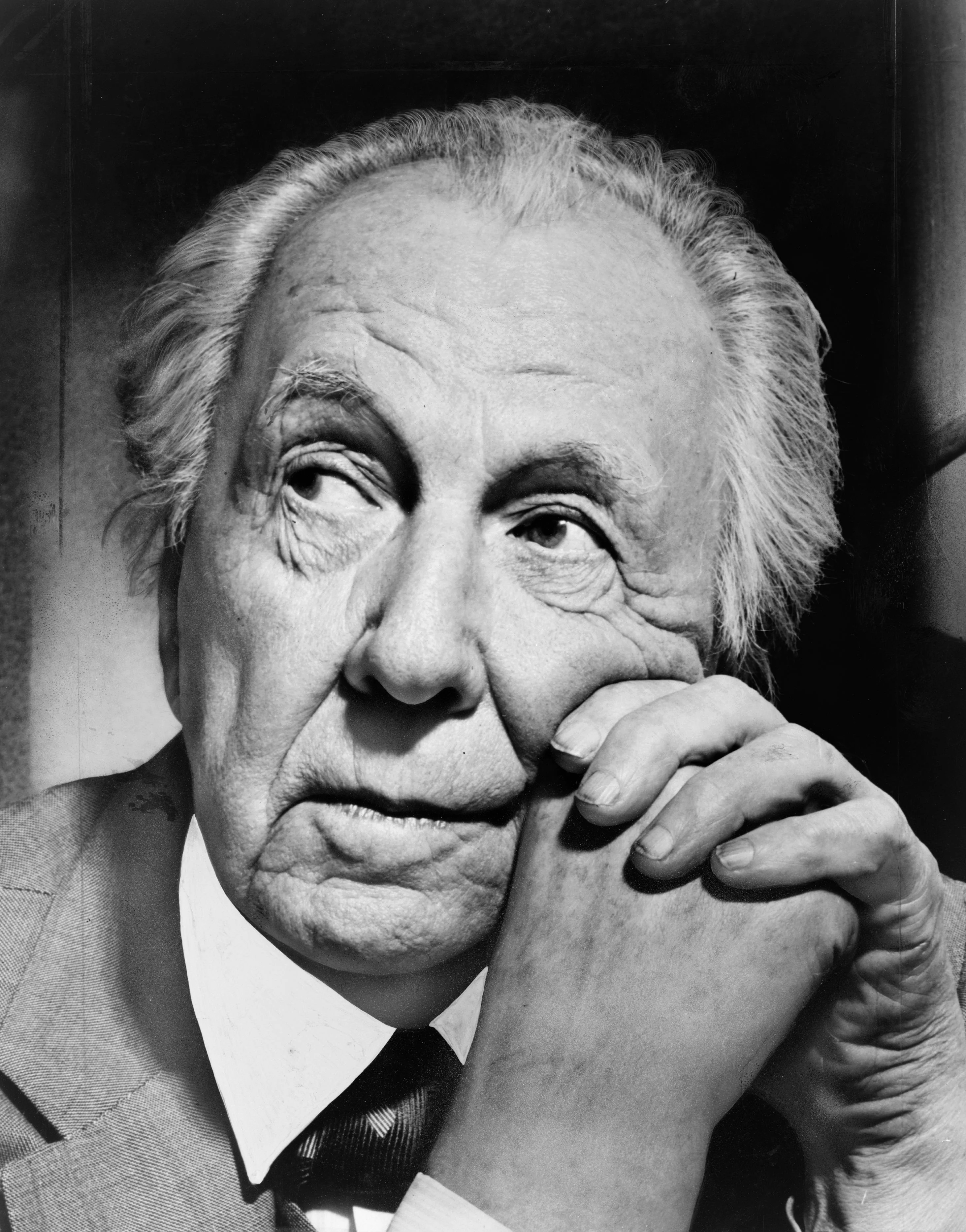 Black and white portrait of an elderly person resting their face on their hand