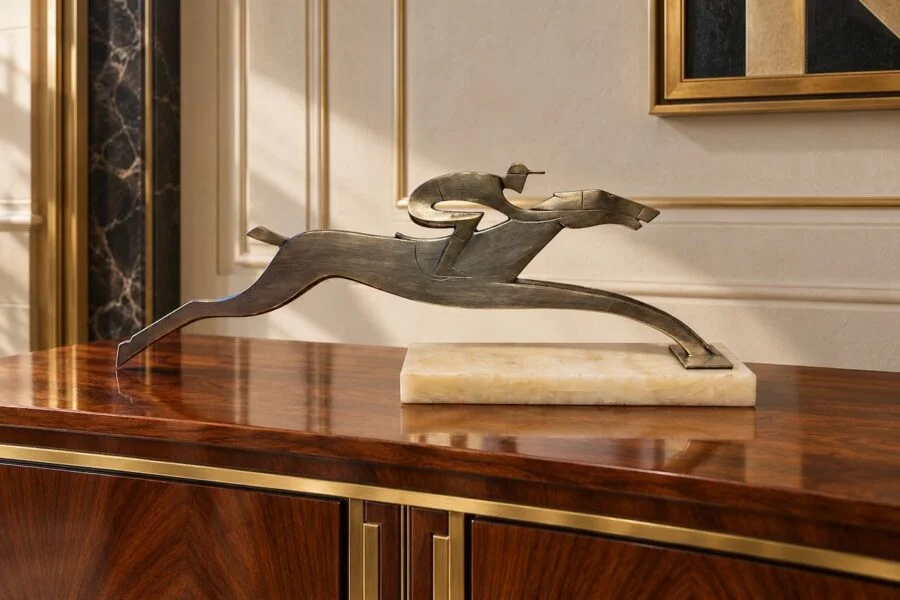 Bronze abstract sculpture of a jockey riding a galloping horse on a marble base
